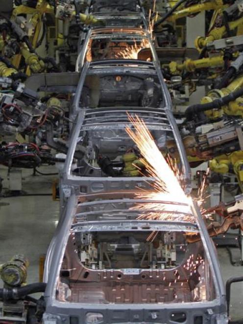Robot arms assemble cars inside  Hyundai's plant in India. Photo by Reuters.