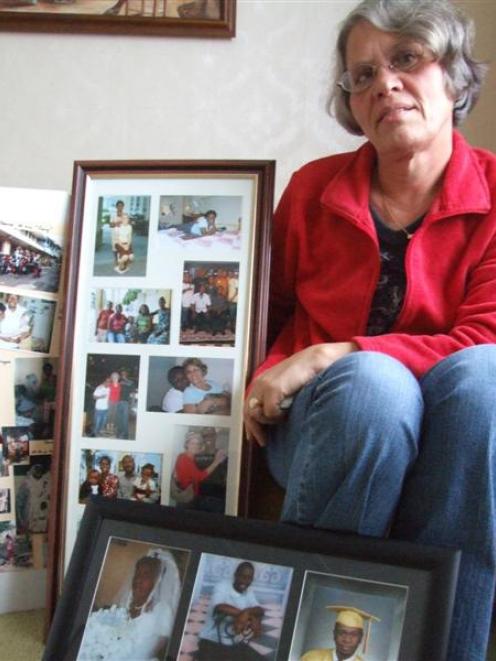 Robyn Couper with photographs of some of her Haitian friends. Photo by Sally Rae.