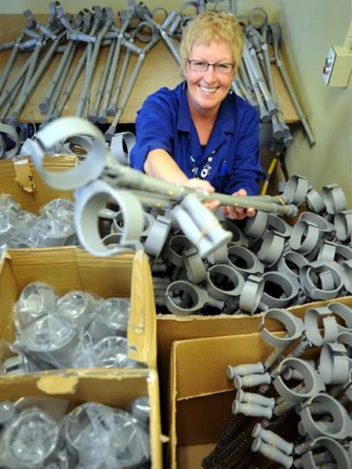 Robyn Hullen, of Orthotics Otago, surrounded by 50 pairs of crutches, the amount to go out to...