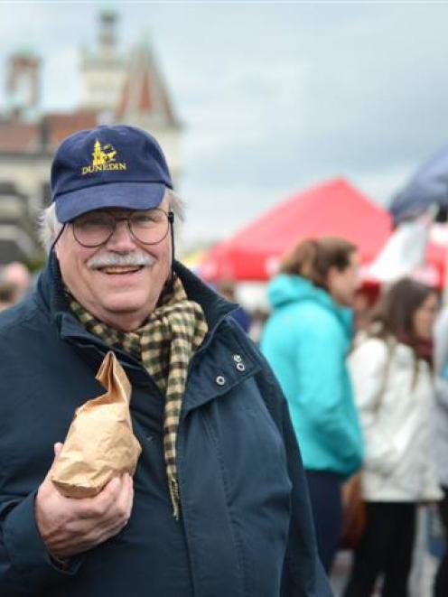 Rodney Bryant, of Dunedin, holds a bag of 30 tulip bulbs, at the farmers market on Saturday, ...