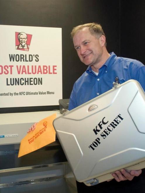 Roger Eaton, president of KFC USA, places Colonel Harland Sanders’ handwritten Original Recipe of...