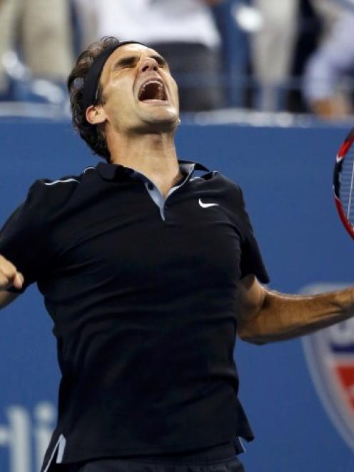 Roger Federer celebrates his win over Gael Monfils in their US Open quarterfinal match. REUTERS...