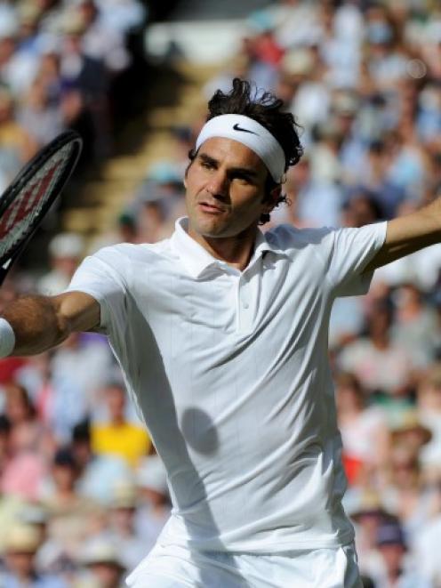 Roger Federer hits a return against Milos Raonic.  REUTERS/Facundo Arrizabalaga/Pool
