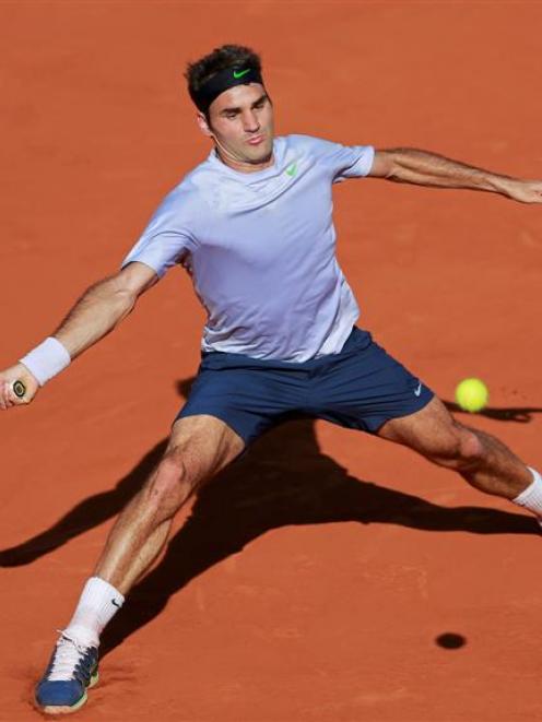 Roger Federer hits a return to Jo-Wilfried Tsonga on his way to a straight sets defeat. REUTERS...