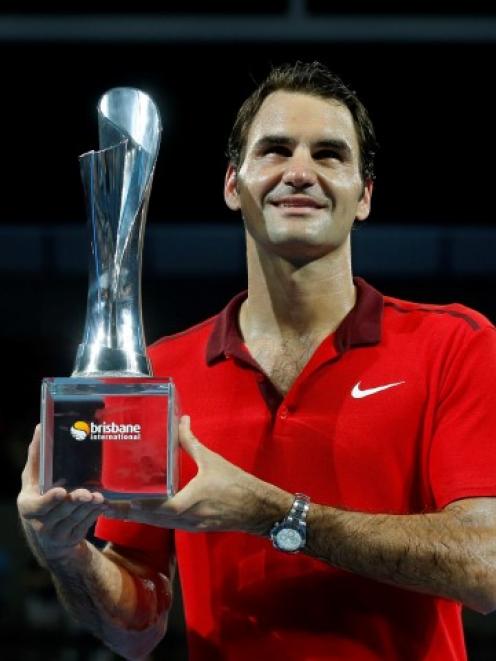 Roger Federer holds the trophy after his win in the Brisbane International tournament. REUTERS...