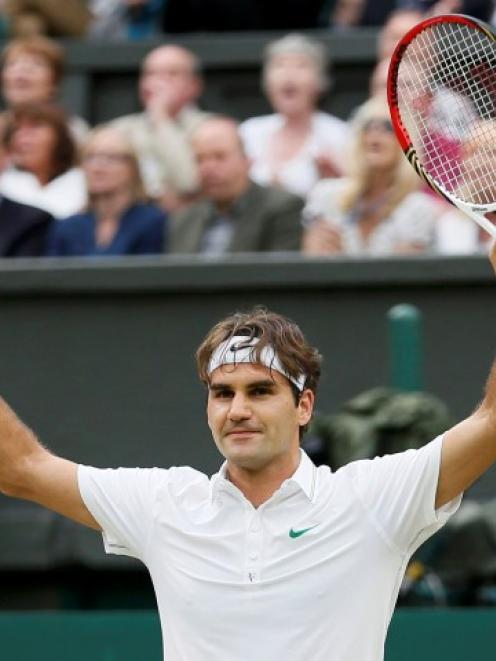 Roger Federer of Switzerland celebrates after defeating Novak Djokovic of Serbia in their men's...