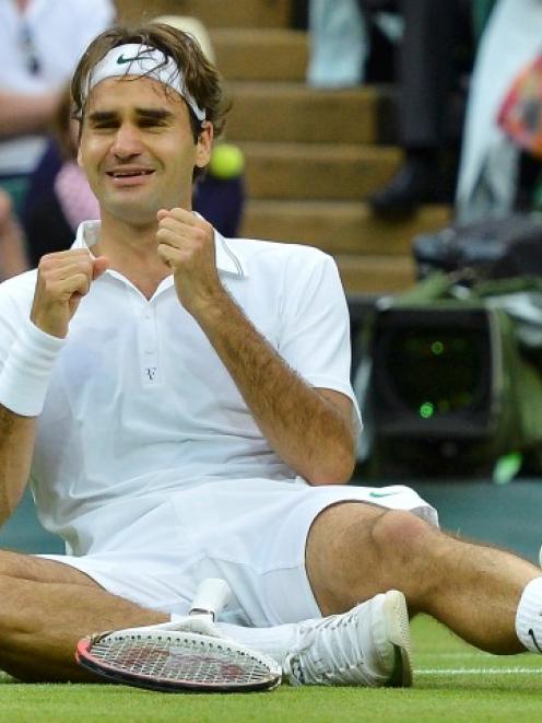 Roger Federer of Switzerland celebrates after defeating Andy Murray of Britain in their men's...