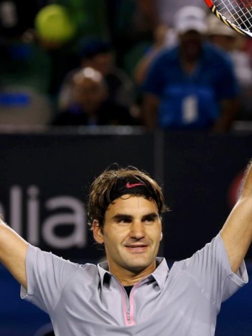 Roger Federer of Switzerland celebrates defeating Jo-Wilfried Tsonga of France in their men's...