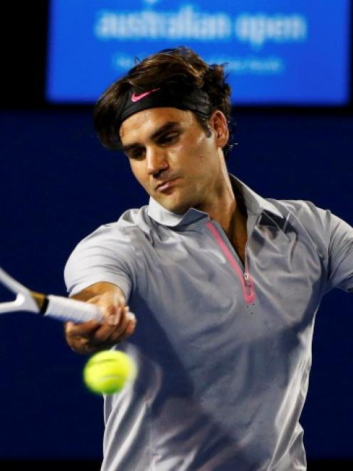 Roger Federer of Switzerland hits a return to Nikolay Davydenko of Russia during their men's...