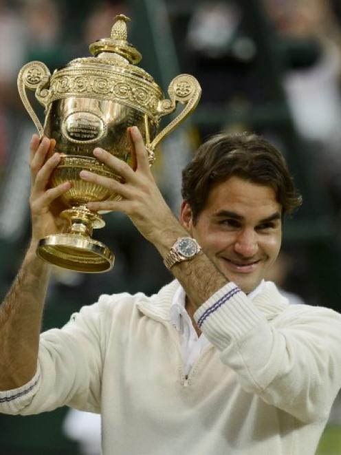 Roger Federer of Switzerland holds the winners trophy after defeating Andy Murray of Britain in...