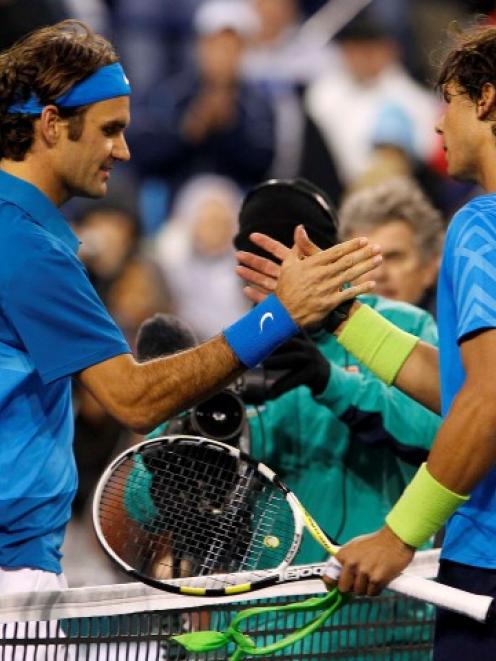 Roger Federer of Switzerland (L) shakes hands with Rafael Nadal of Spain after defeating him in...