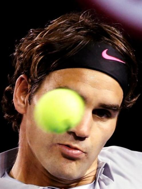 Roger Federer of Switzerland watches the ball during his men's singles match against Bernard...