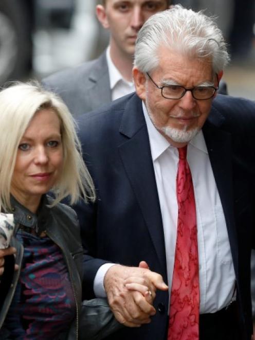 Rolf Harris arrives with his daughter Bindi at Southwark Crown Court in London. REUTERS/Luke...