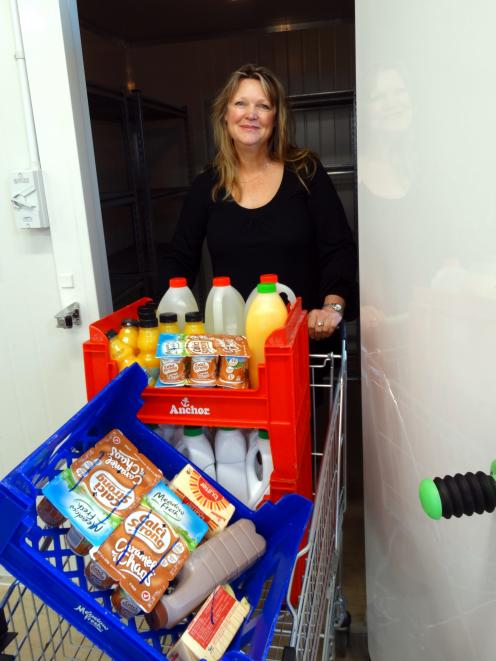 FoodShare manager Pip Wood wheels another load of food from the chiller. The organisation needs...