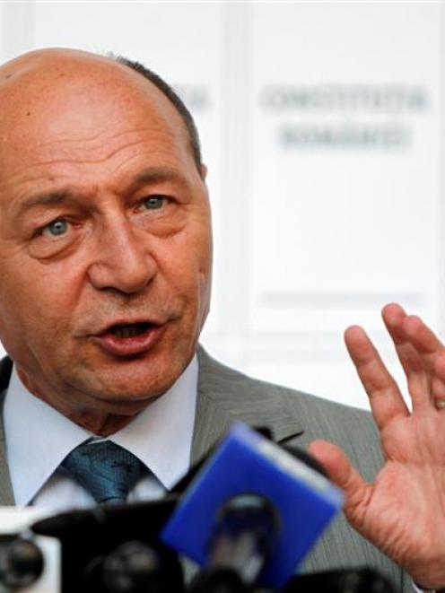Romania's suspended President Traian Basescu addresses media at his campaign headquarters....