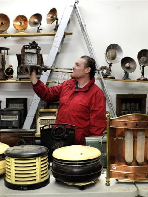 Ronald A Proctor Auctioneers manager Ricky Proctor examines a Welshbach Kern heater, part of the...