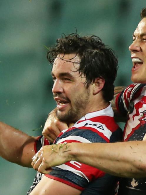 Roosters players Aidan Guerra (L) and Sonny Bill Williams celebrate Guerra's try against the...