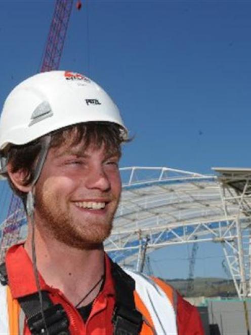 Rope-access technician Chris Price, of England, is one of 11 workers tasked with climbing to the...