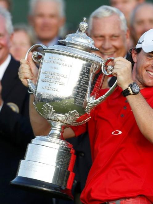 Rory McIlroy of Northern Ireland lifts the Wanamaker Trophy after capturing PGA Championship at...