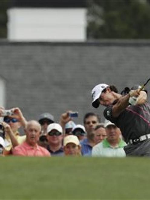 Rory McIlroy, of Northern Ireland, tees off on the first hole during a practice round yesterday...
