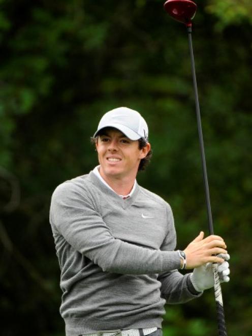 Rory McIlroy watches the path of his tee shot on the 3rd hole during the first round in the Honda...