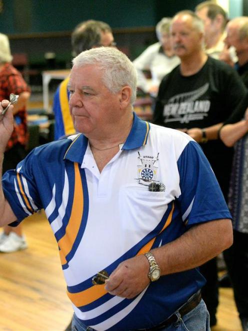 Ross Abernethy prepares to throw a dart in the mixed fours competition at the Otago Darts...