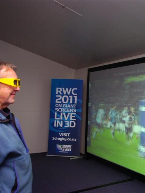 Rugby fan Jim Finnerty watches a promotion for 3-D rugby screenings inside the 3DLive demo truck...