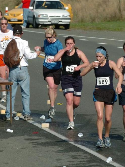 Runners stop at a drink station at Sawyers Bay during a previous Dunedin Marathon. Photo by ODT...