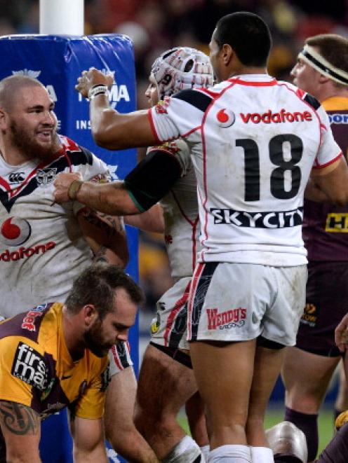 Russell Packer celebrates with Warriors teammates after scoring against the Broncos at Suncorp...