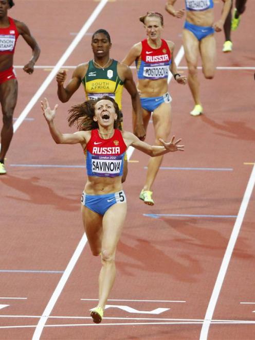 Russia's Mariya Savinova reacts as she crosses the finish line to win gold in the women's 800m....