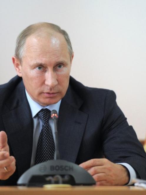 Russia's President Vladimir Putin chairs a meeting on the aftermaths of recent floods in...