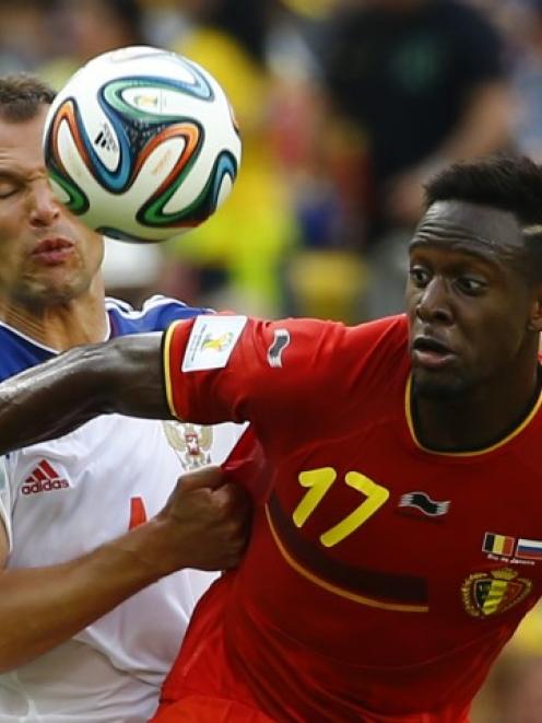 Russia's Sergey Ignashevich (L) fights for the ball with Belgium's Divock Origi. REUTERS/Pilar...