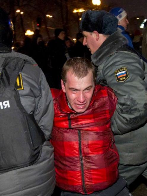 Russian police detain a participant during an opposition protest demanding fair elections in...