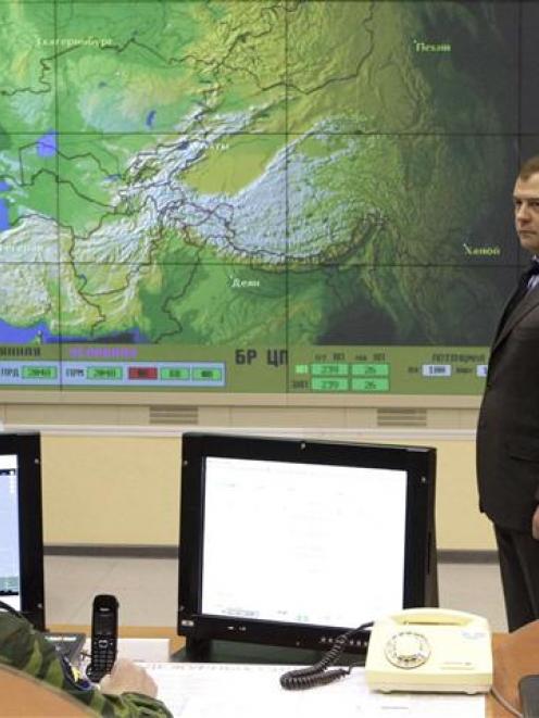 Russian President Dmitry Medvedev (looks on during a visit to an early-warning radar station near...