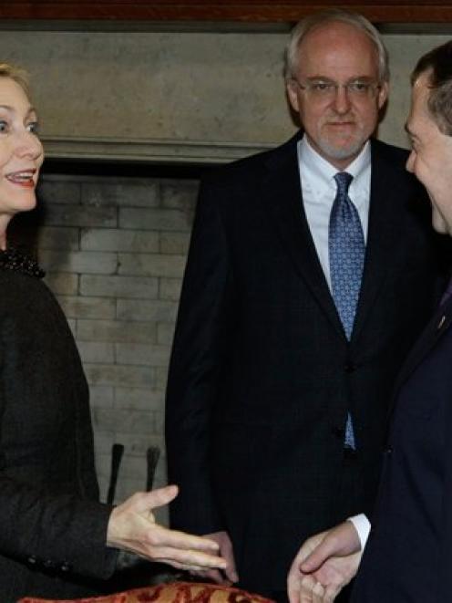 Russian President Dmitry Medvedev, right, greets US Secretary of State Hillary Rodham Clinton...