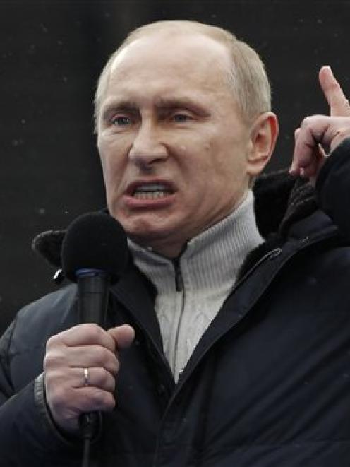 Russian Prime Minister Vladimir Putin speaks at a rally in his support at Luzhniki stadium in...
