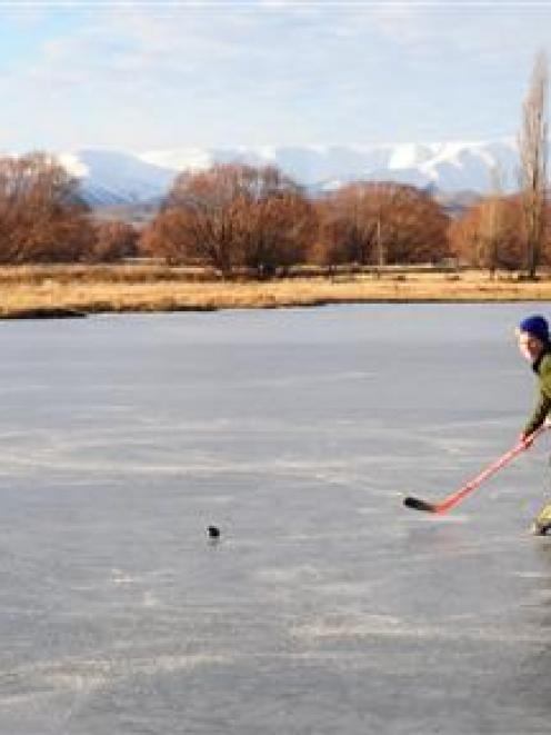 Ryan Becker (8), of nearby Wedderburn, enjoys the smooth ice on the Idaburn dam, near Oturehua,...