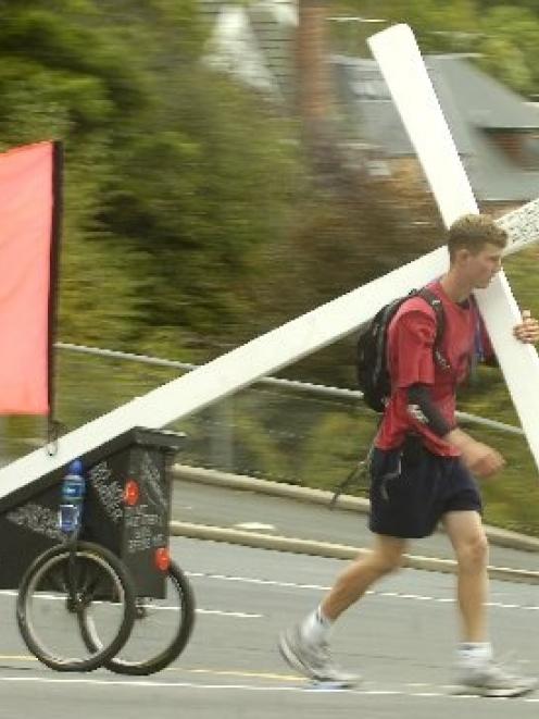 Ryan Craig of Oamaru carrying his cross. Photo by Peter McIntosh.