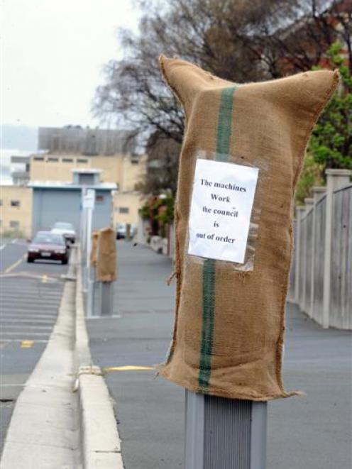 Sacks that appeared on parking meters and lights in the city yesterday, with messages critical of...