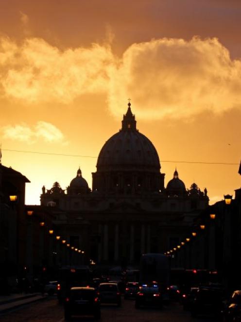Saint Peter's Basilica at the Vatican is silhouetted during sunset in Rome. REUTERS/Paul Hanna