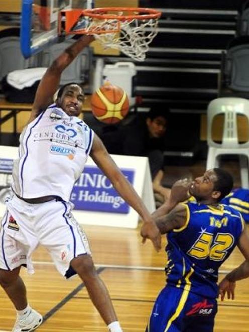 The Wellington Saints' Ernest Scott climbs above the Otago Nuggets' Antoine Tisby to score during...