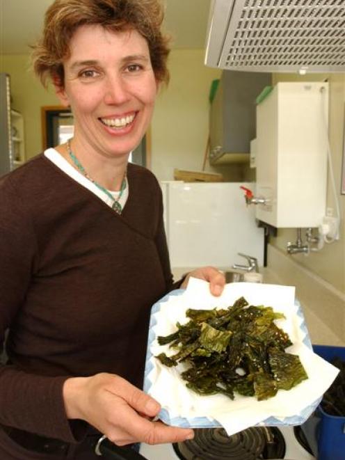 Sally Carson holds a plate of seaweed chip[s. Photo by Jane Dawber.