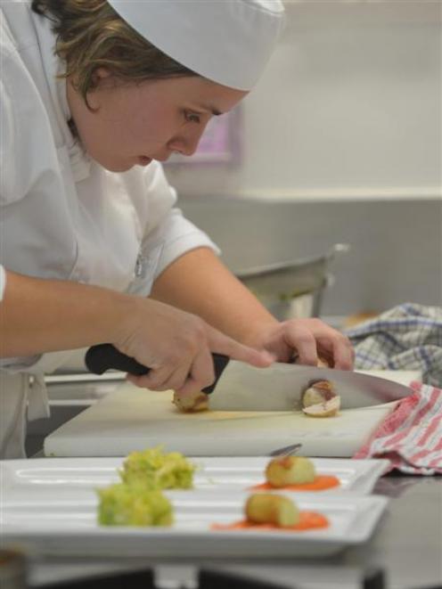 Salon Culinaire competitor Marcela Garvalho, of Queenstown, prepares her poached chicken dish at...