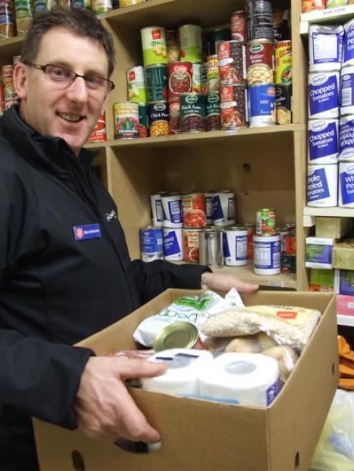 Salvation Army community worker Blair McKenzie in the Camp St store stocks up the Queenstown...