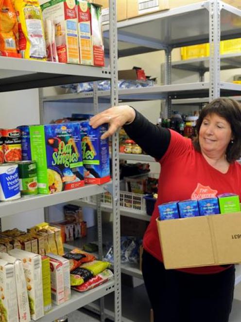 Salvation Army Dunedin Captain Susan McGregor sorts donations at the foodbank yesterday. Photo by...