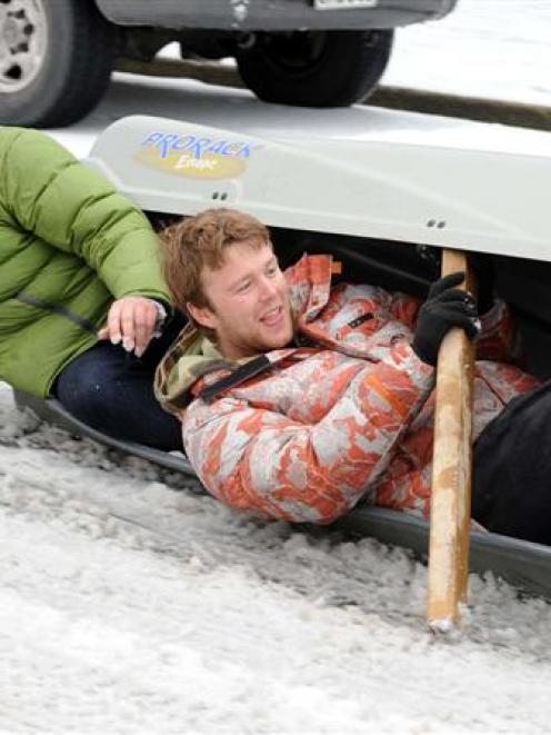 Sam Broadmore (left) and Josh Richardson improvise and slide on  a car carry pod on London St, in...