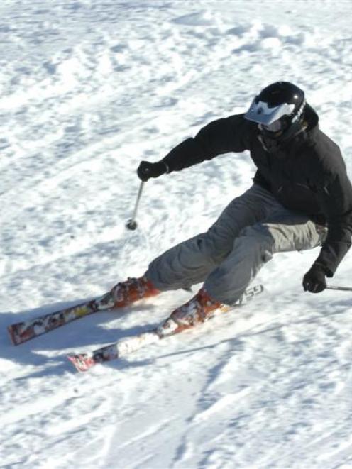 Sam Hazeldine speeds around a banked turn while training on the ski-cross course at Cardrona...