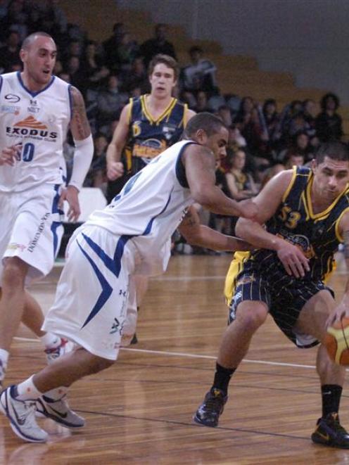 Sam To'omata (53), of the Otago Nuggets, is challenged by Wellington's  Corey Webster (9) as Leon...