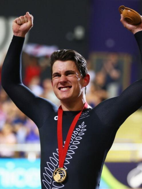 Sam Webster celebrates on the podium after winning the men's cycling sprint final. (Photo by...