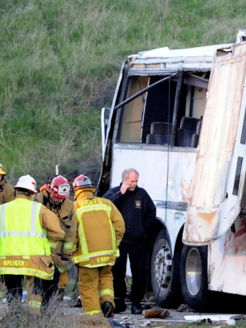San Bernardino firefighters converge on the scene of a crash by a Mexico-bound tour bus in...